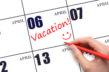A hand writing a VACATION text and drawing a smiling face on a calendar date 6 April. Vacation...