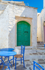 Fototapeta premium A wooden green colored door of a Beautiful traditional house in Chora the capital of Amorgos island in Greece