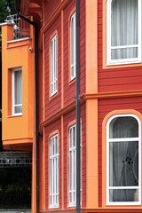 Part of red-orange colorful building, exterior detail