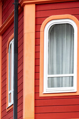 Obraz premium Part of red-orange colorful building, exterior detail