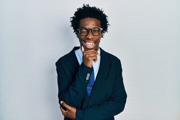 Young african american man wearing business suit and tie winking looking at the camera with sexy...