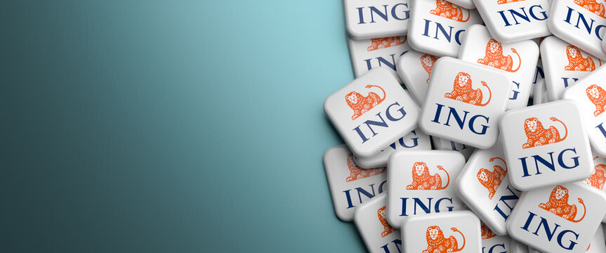 Logos of the Dutch banking and financial services company ING Group on a heap on a table. Copy space. Web banner format.