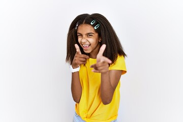 Young african american girl standing over white isolated background pointing fingers to camera with...