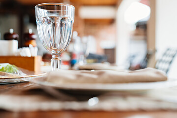 empty wine glass. setting of a wooden table on the veranda.