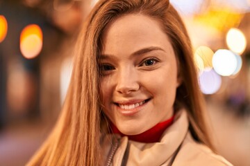 Young blonde woman smiling confident standing at street