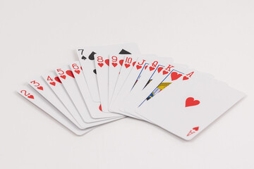 Set of playing cards in a horizontal spread with one different card isolated