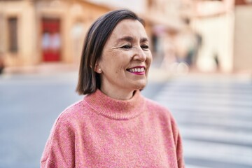 Middle age woman smiling confident standing at street