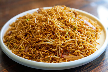 A plate of delicious Hong Kong style fried noodles with soy sauce