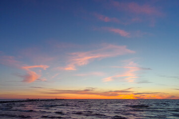 Colorful orange sunset over Baltic sea on clear summer day
