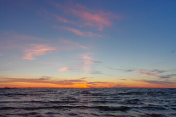 Colorful orange sunset over Baltic sea on clear summer evening