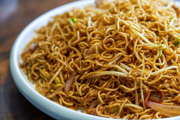 A plate of delicious Hong Kong style fried noodles with soy sauce