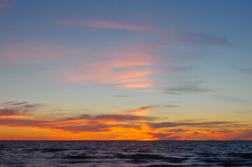 Fototapeta na wymiar Colorful orange sunset over Baltic sea on clear summer day