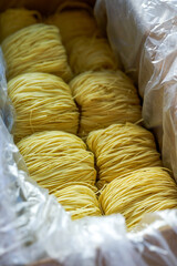 Pile of slender Cantonese style bamboo noodles dough