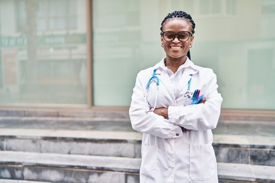 African american woman doctor smiling confident standing with arms crossed gesture at hospital