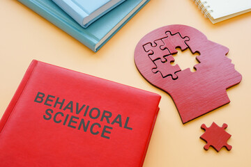 Book Behavioral Science and head shape with puzzles.