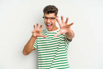 Young caucasian man isolated on white background showing claws imitating a cat, aggressive gesture.