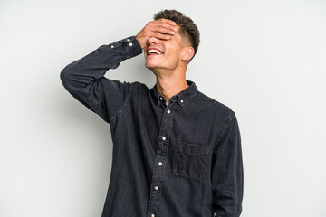 Obraz premium Young caucasian man isolated on white background laughs joyfully keeping hands on head. Happiness concept.