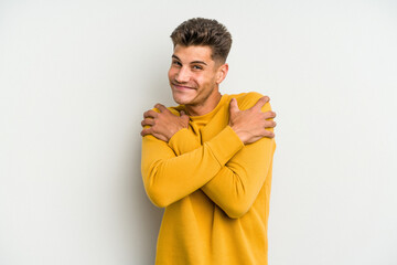 Young caucasian man isolated on white background hugs, smiling carefree and happy.