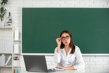 Surprised student preparing exam and learning lessons in school classroom.