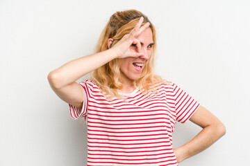Young caucasian woman isolated on white background excited keeping ok gesture on eye.