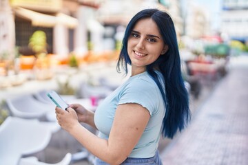 Young caucasian woman smiling confident using smartphone at street