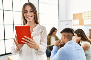 Group of business workers working sitting on the table. Woman smiling happy and using touchpad standing at the office.
