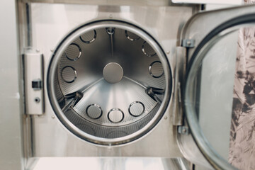 Dry cleaning dry dryer clothes. Clean cloth chemical process. Open door close machine washing