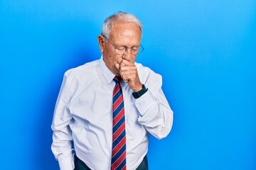 Senior man with grey hair wearing business suit and tie feeling unwell and coughing as symptom for cold or bronchitis. health care concept.