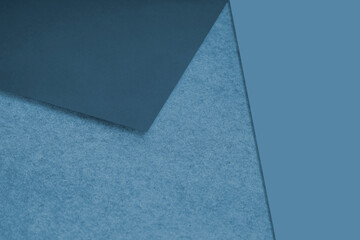 Plain and Textured blue papers randomly laying to form M like pattern and triangle for creative cover design idea