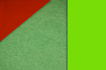Textured and plain neon green red sheet papers forming two triangles and vertical blank rectangle for creative cover designing