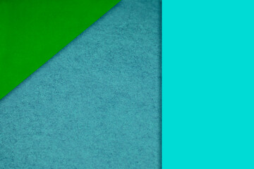 Textured and plain neon blue green sheet papers forming two triangles and vertical blank rectangle for creative cover designing