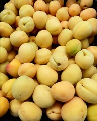Fresh ripe fruits are on the counter in the store. Peaches, apricots, nectarines.