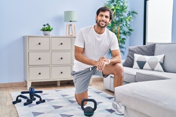 Young hispanic man sporty using stopwatch at home