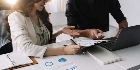 Business team finance or bookkeeper working with a calculator to calculate business data summary...