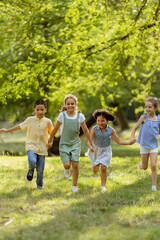 Group of asian and caucasian kids having fun in the park