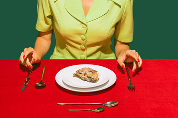 Cropped image of woman eating oyster on red tablecloth isolated over green background