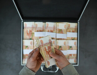 A metal suitcase filled with Russian banknotes of 5000 rubles. Investment, bribe, corruption concept.