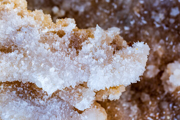 Macro of white crystals of rock sea salt. Blurred background of salts crystals from the Dead Sea....