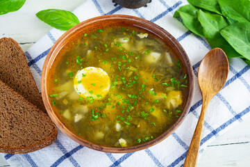 Sorrel soup in bowl. Traditional russian green soup with sorrel