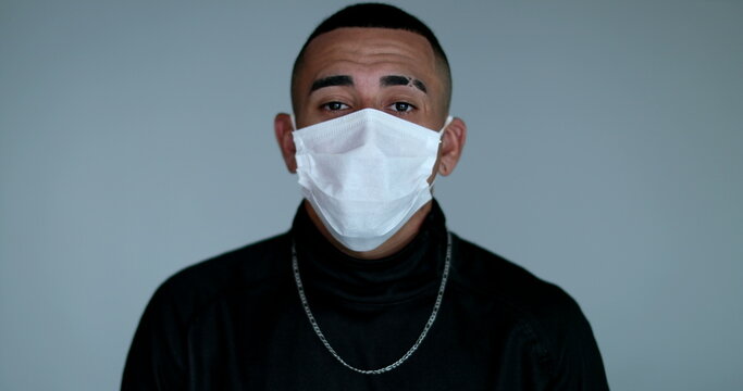 Hispanic Latino Young Man Adjusting Face Mask