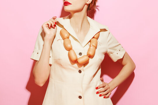 Naklejki Cropped image of woman having necklace made from sausages. Creative food advertisement