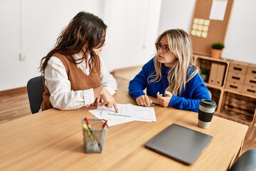 Two business workers woman smiling happy working at the office.
