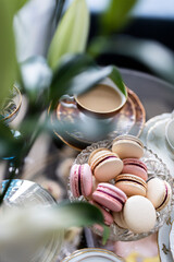 A dessert table setting with macaroons, coffee and champagne all in a light atmosphere Nr.1