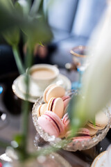 A dessert table setting with macaroons, coffee and champagne all in a light atmosphere Nr.4
