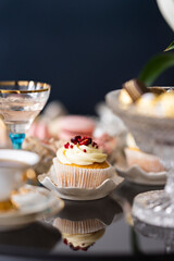 A reflection of a delicious cupcake on a glass table top in the morning