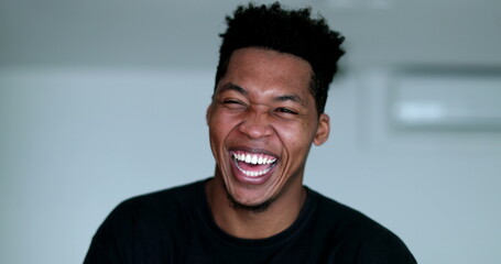 Happy young African American black man laughing and smiling