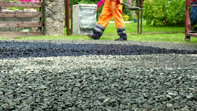 Construction site is laying new asphalt road pavement,road construction workers and road construction machinery scene.