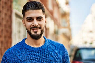 Young arab man smiling confident at street