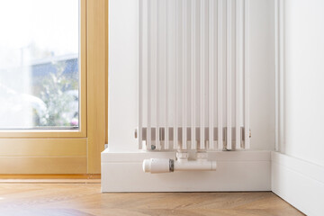 Heating radiator in room with wooden floor