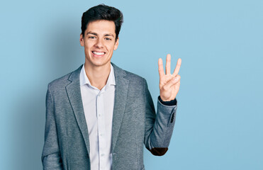 Young hispanic man wearing business clothes showing and pointing up with fingers number three while...